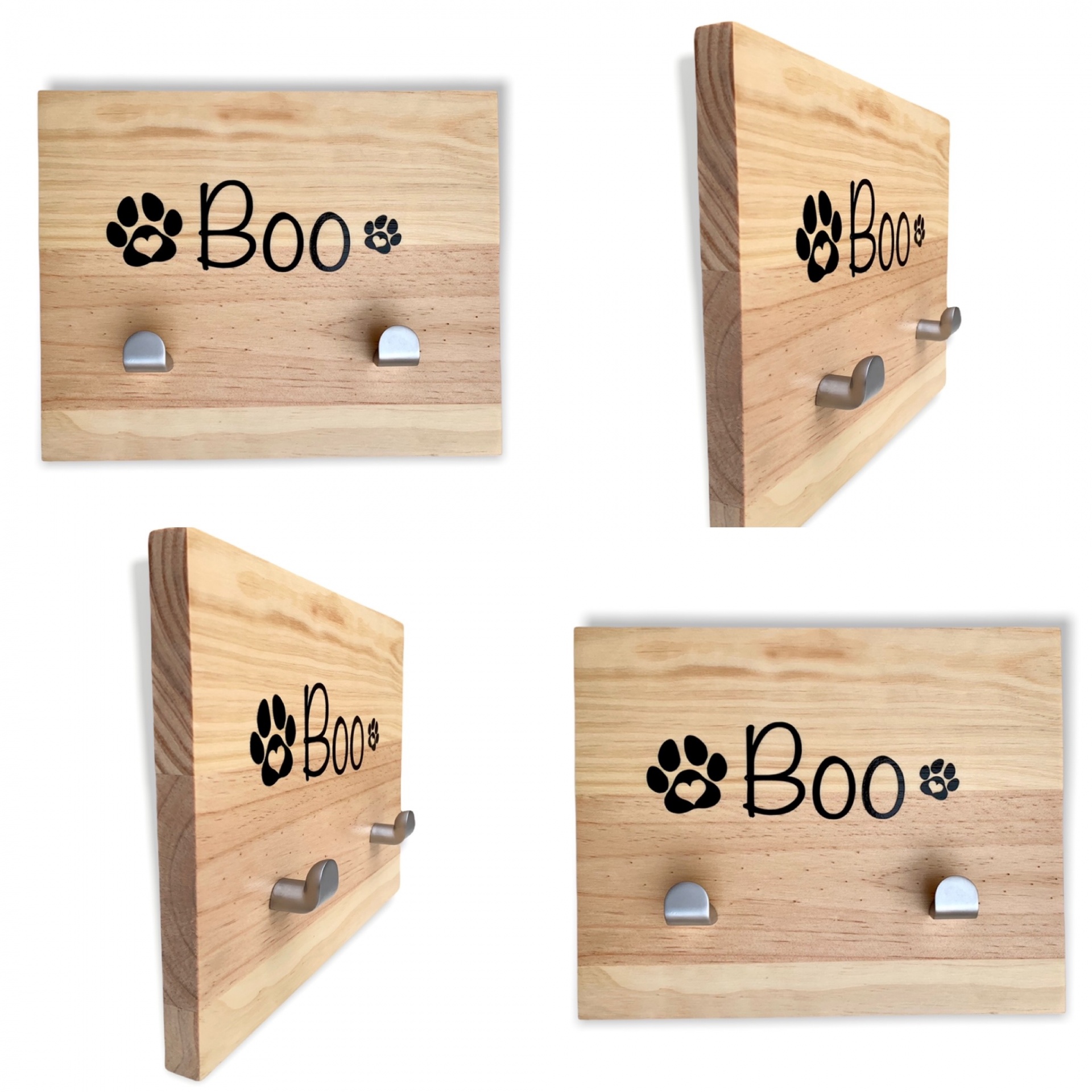Cabide de madeira clara com duas pegas metálicas e a palavra 'Boo' com pegadas de patas pretas.