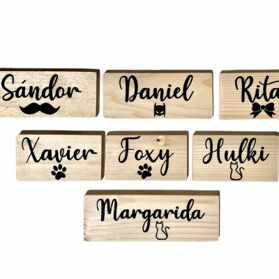 Placas de madeira com nomes e símbolos em preto