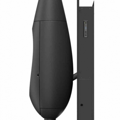 dispositivo eletrônico preto com bases circulares, junto a uma parede cinza com botões