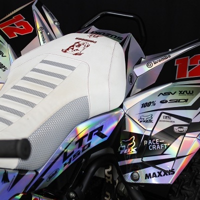 Mini moto com assento branco e autocolantes brilhantes laterais sobre fundo preto