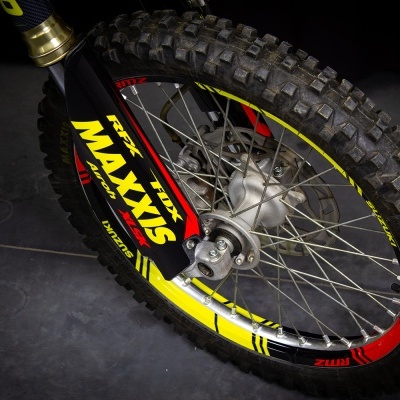 Roda de bicicleta de montanha com pneu preto Maxxis sobre piso escuro