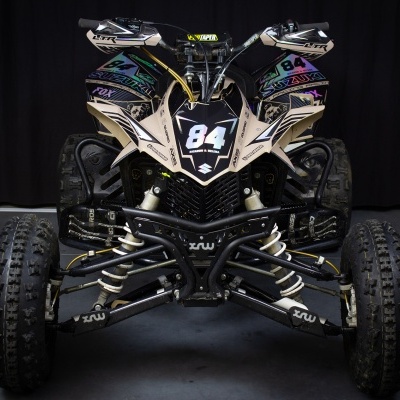 Quadriciclo todo-o-terreno preto com número 84 e grafismos coloridos