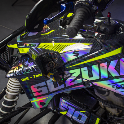 Mota Suzuki com pintura em carbono preto e amarelo fluorescente, decalques coloridos e texto visível