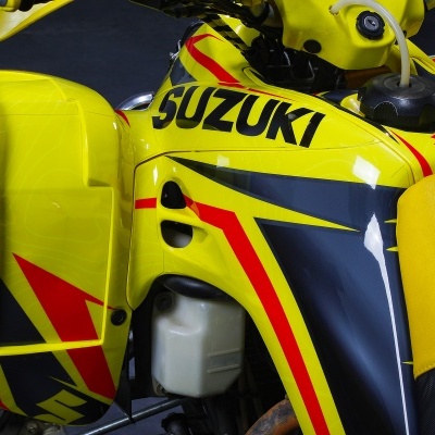 Motociclo Suzuki amarelo com detalhes vermelhos e pretos