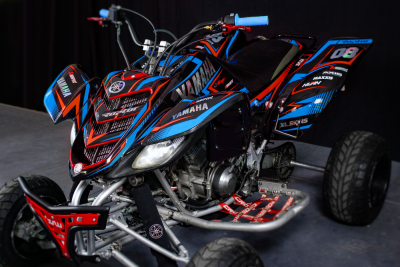 Quadro Yamaha preto com detalhes vermelhos e azuis e punhos azuis