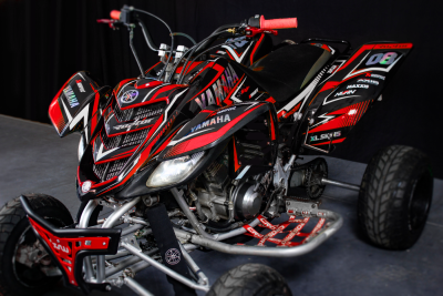 Quad Yamaha vermelho e preto com número 06 e pneus largos
