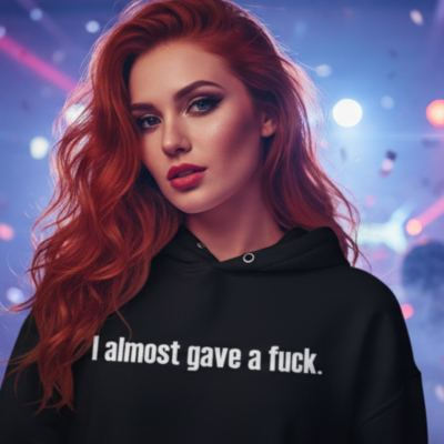 Mulher com hoodie preto e cabelo ruivo com texto branco 'I almost gave a fuck.' em fundo luminoso desfocado