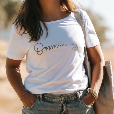 Mulher com t-shirt branca estampada e calças de ganga claras