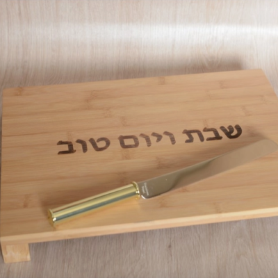 Tabuleiro de madeira com gravação em hebraico e faca com cabo dourado