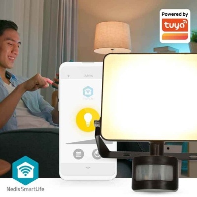 Lâmpada retangular branca com sensor de movimento preto e smartphone numa sala