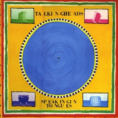 Pintura colorida com círculo azul e prédios em quadrados, texto 'TALKING HEADS' e 'SPEAKING IN TONGUES'