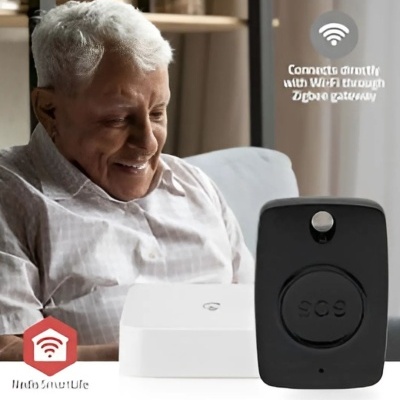Dispositivo SOS preto ao lado de gateway branco com homem idoso ao fundo sorrindo sentado no sofá