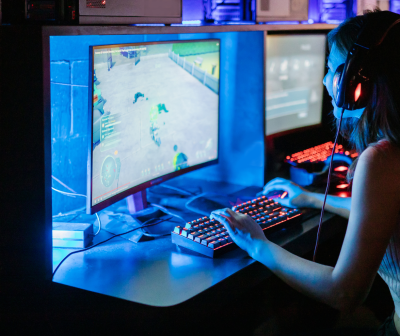 Computador gaming com ecrã curvo e teclado retroiluminado em mesa azul