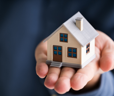 Miniatura de casa em miniatura nas mãos
