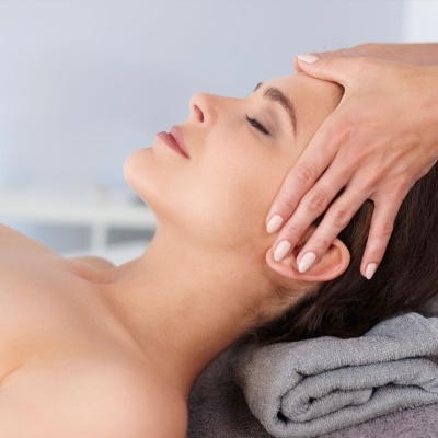 Mulher a receber massagem na cabeça num spa