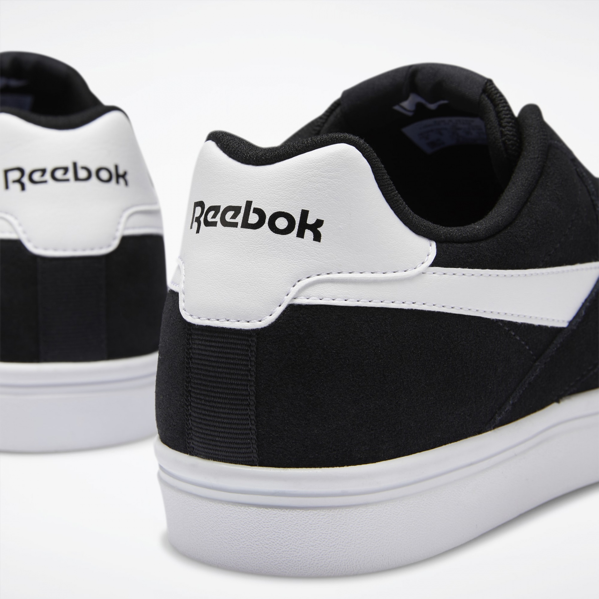 Sapatilhas desportivas Reebok preto e branco vistas de trás