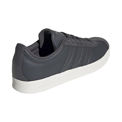 Ténis Adidas cinzento escuro com sola branca e três riscas características