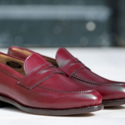 Sapatos mocassim em couro vermelho com sola de couro castanha.