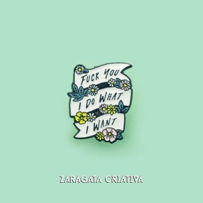 Pin metálico com texto e flores em fundo verde claro