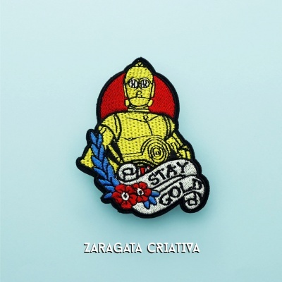 Broche bordado com personagem amarelo e texto STAY GOLD