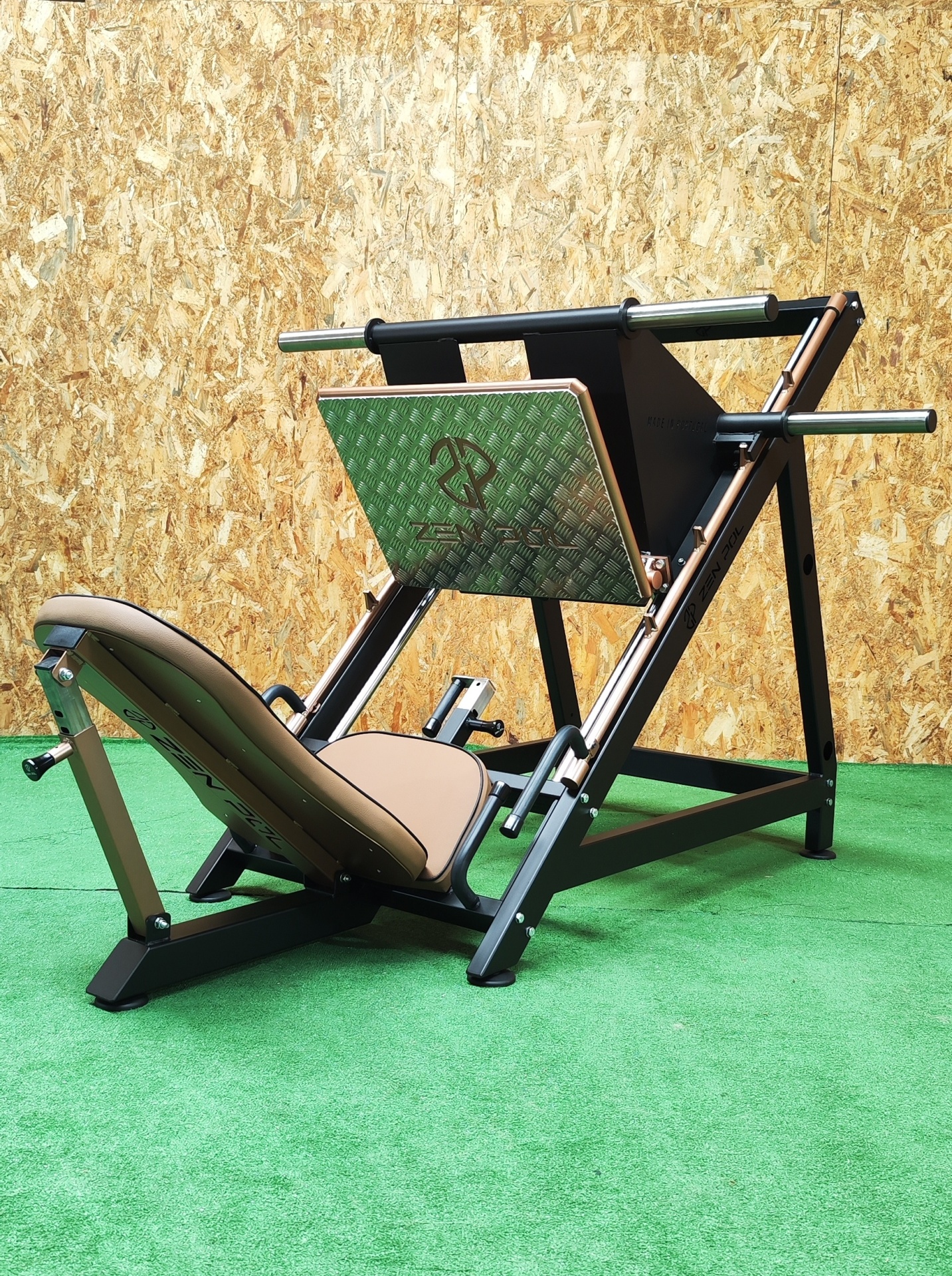 Máquina leg press preta com assento castanho e placa metálica