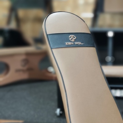 Banco de exercício bege com faixa preta e logotipo ZEN POL em ginásio