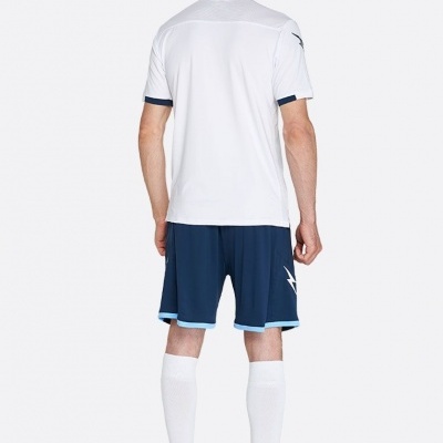 Homem de costas com roupa desportiva branca e azul, meias brancas e sapatilhas amarelas.