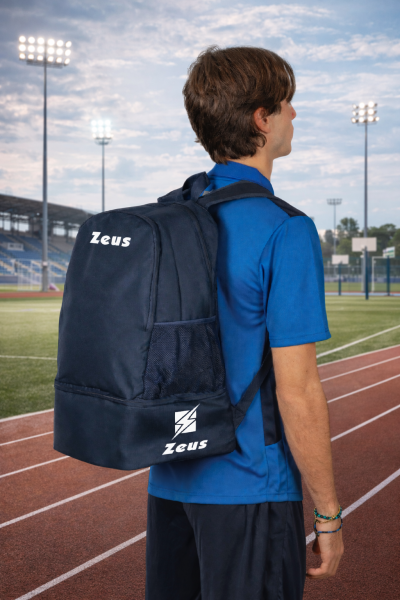 Mochila desportiva azul escura com o logotipo Zeus num campo de atletismo